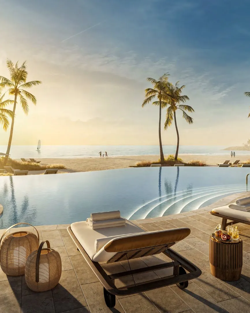 Infinity pool with loungers looking over the beach towards the sea