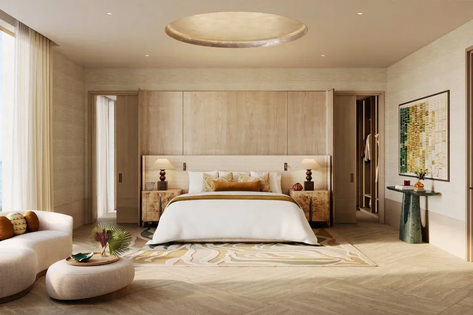 Main bedroom in warm timber tones with a window onto the sea